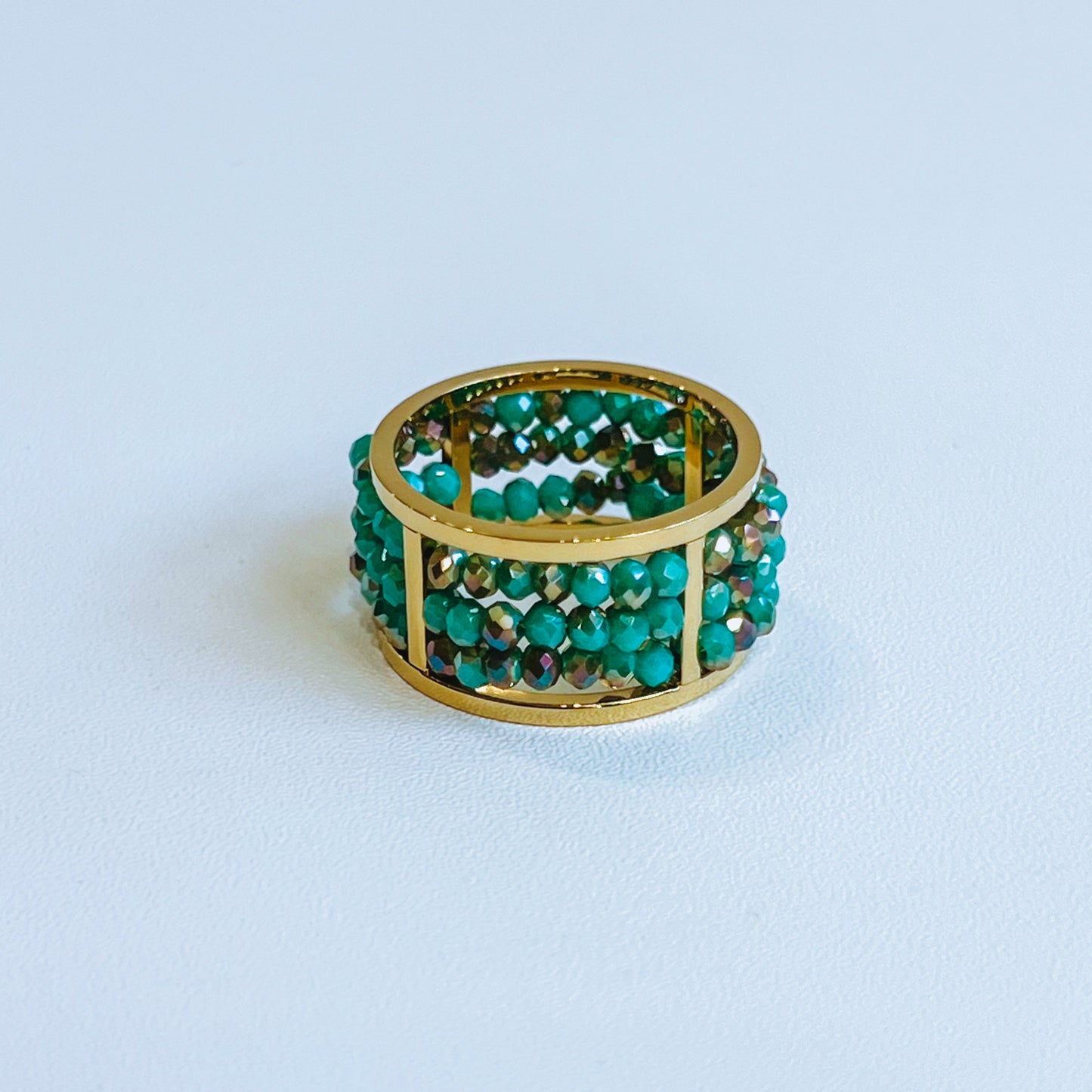 Abaco Ring - Aquamarine Gold ring green gems on a light background