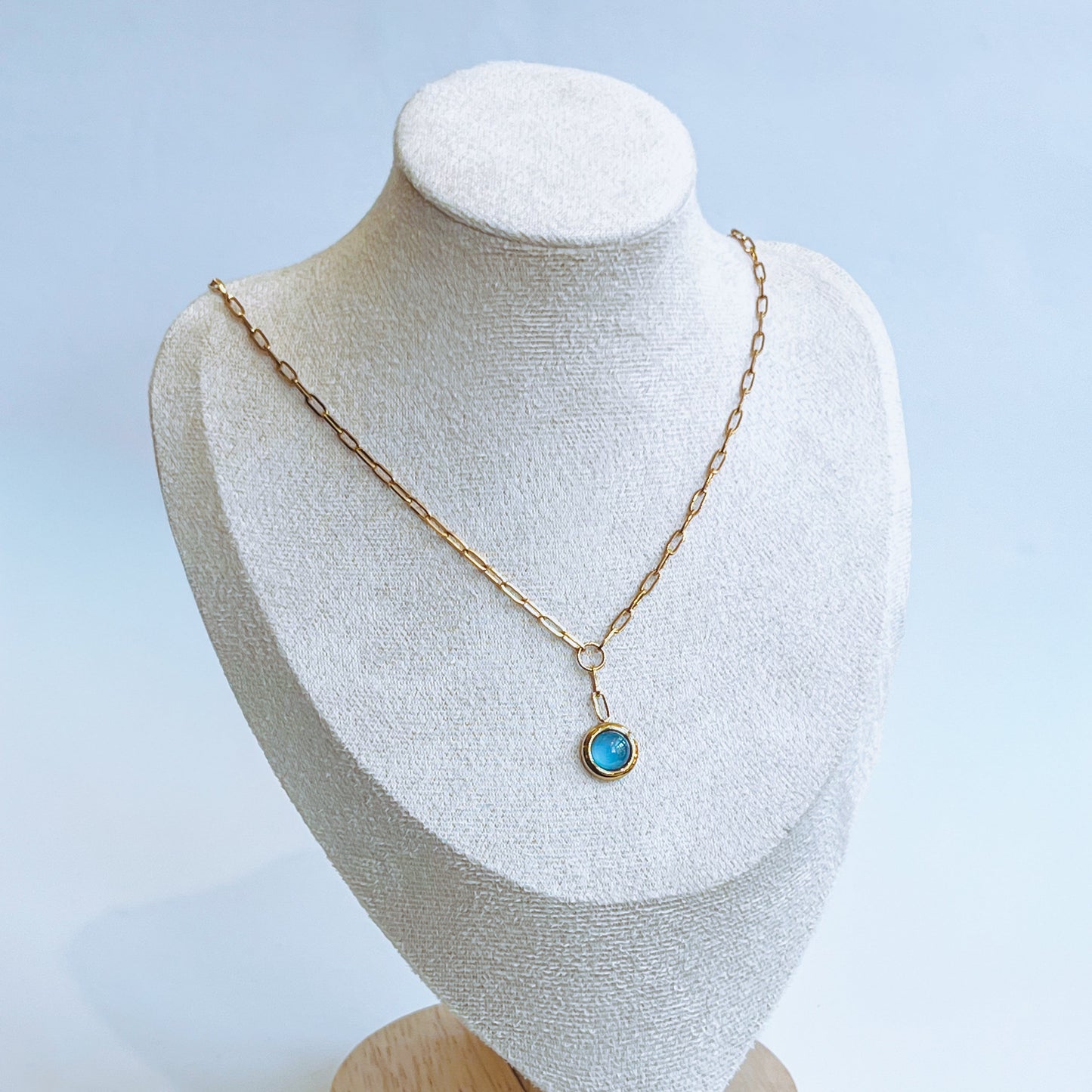 Azure Pendant Necklace with a blue pendant on a mannequin bust against a light background