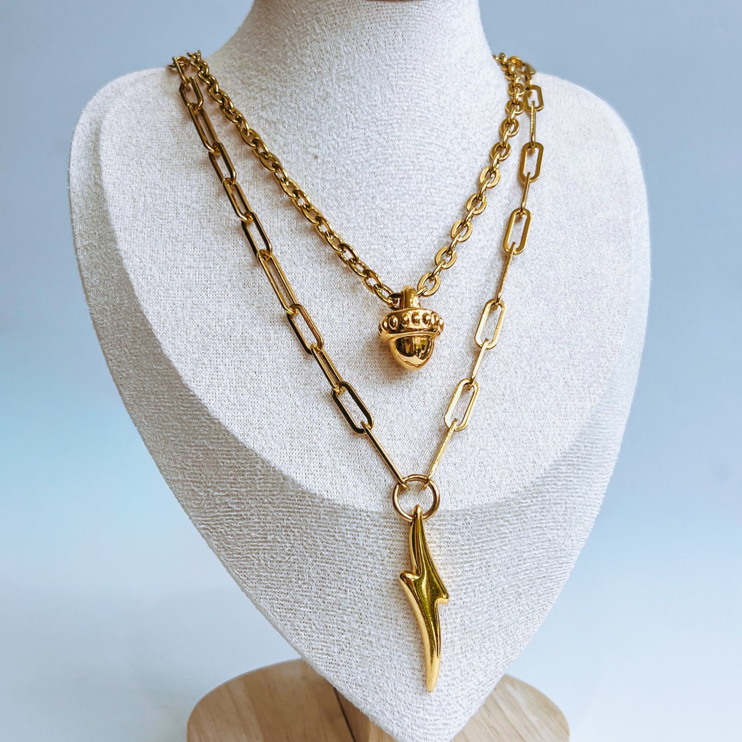 Bottom Double Necklace Gold layer two chain necklace on a mannequin bust with a light background