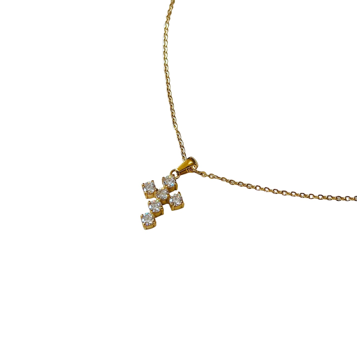 close up Cross Pendant Necklace Gold necklace with a cross-shaped pendant on a light background