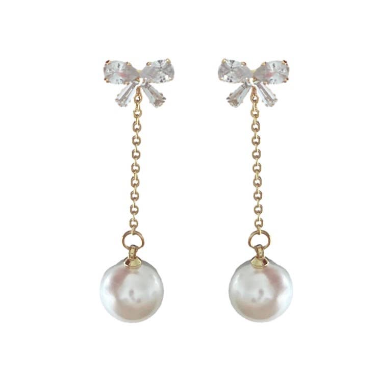 Crystal Bow and Pearl Drop Earrings Pair of earrings with crystal bow tops and pearl drops on a white background
