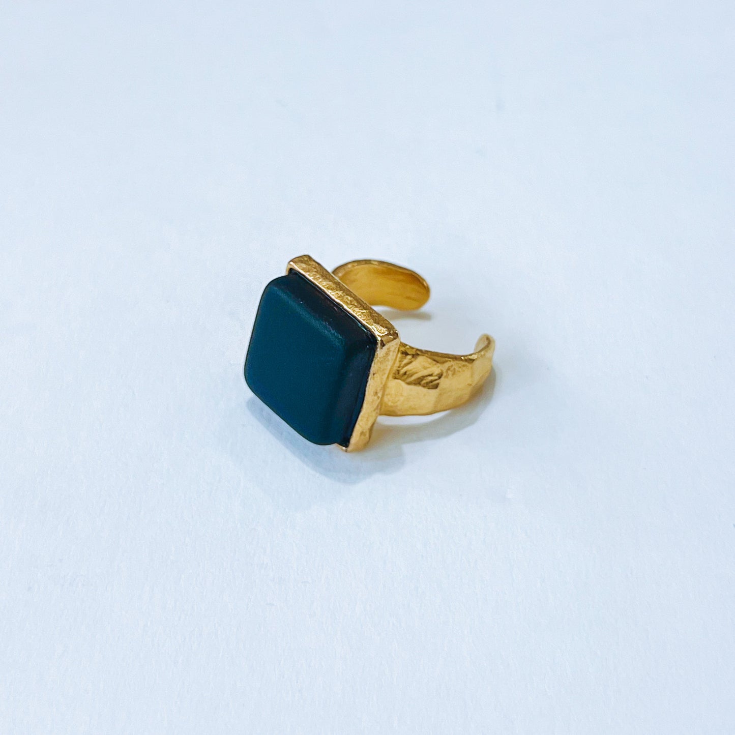 Cube Ring Gold - Cobalt Gold ring with a blue sea glass stone on a light background