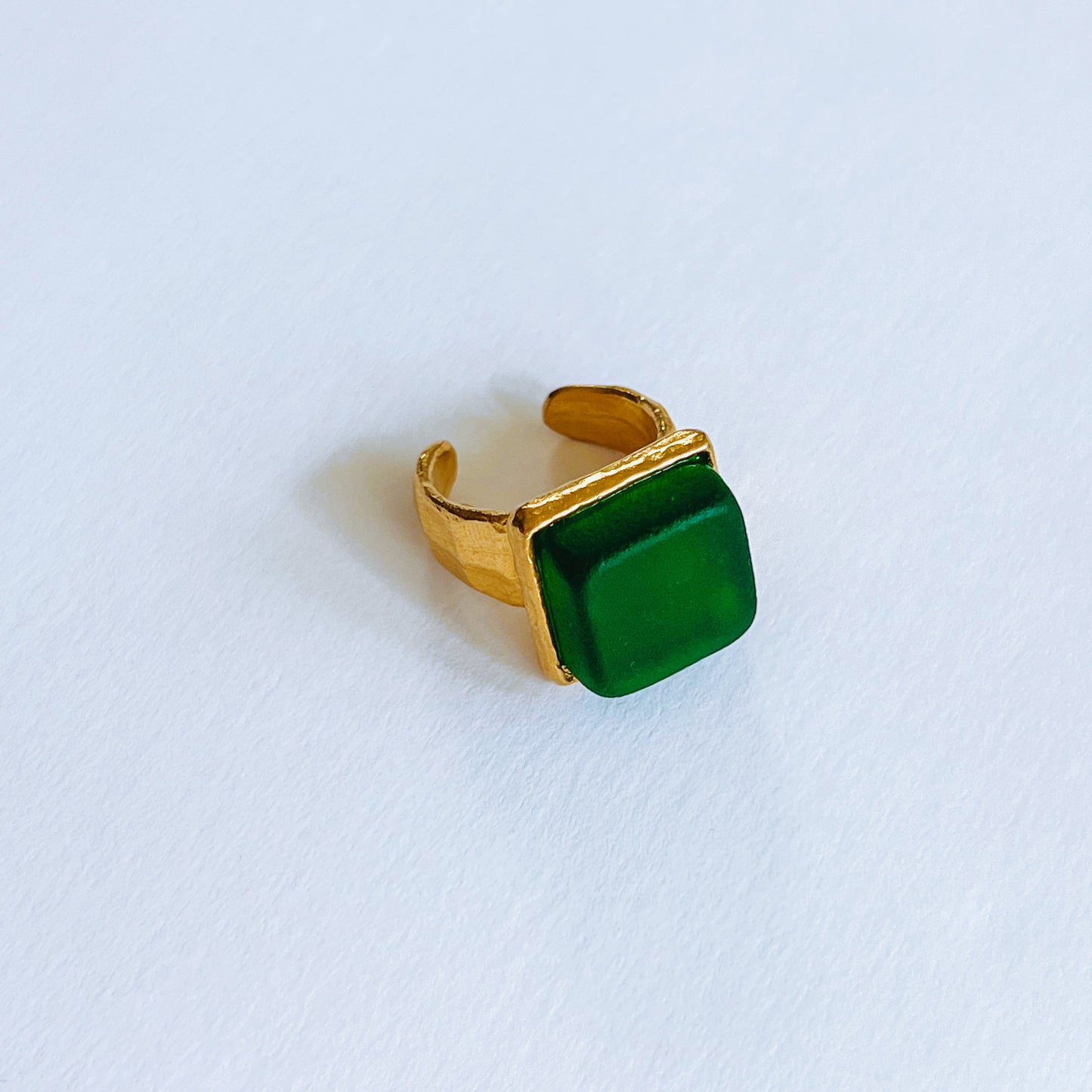 Cube Ring Gold - Pine Gold plated ring with a green square sea glass on a light background