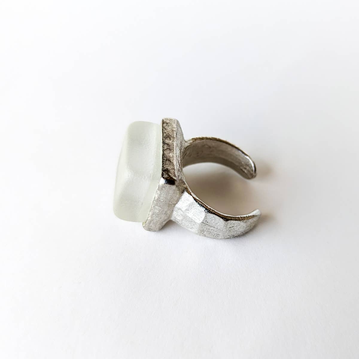 silver recycled glass cube statement ring with textured surfaces and cube recycled glass stone on a white background