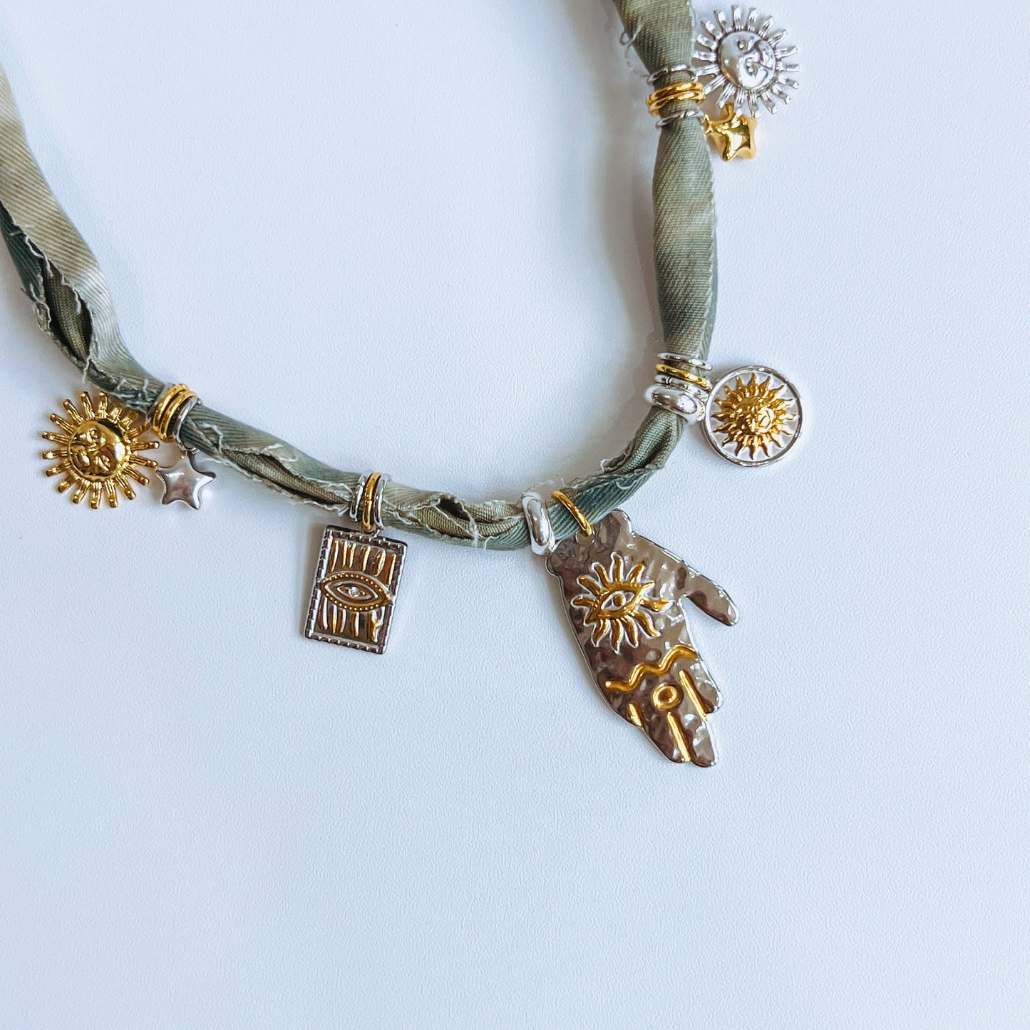 Denim Charm Necklace denim fabric Necklace with various charms on a white background