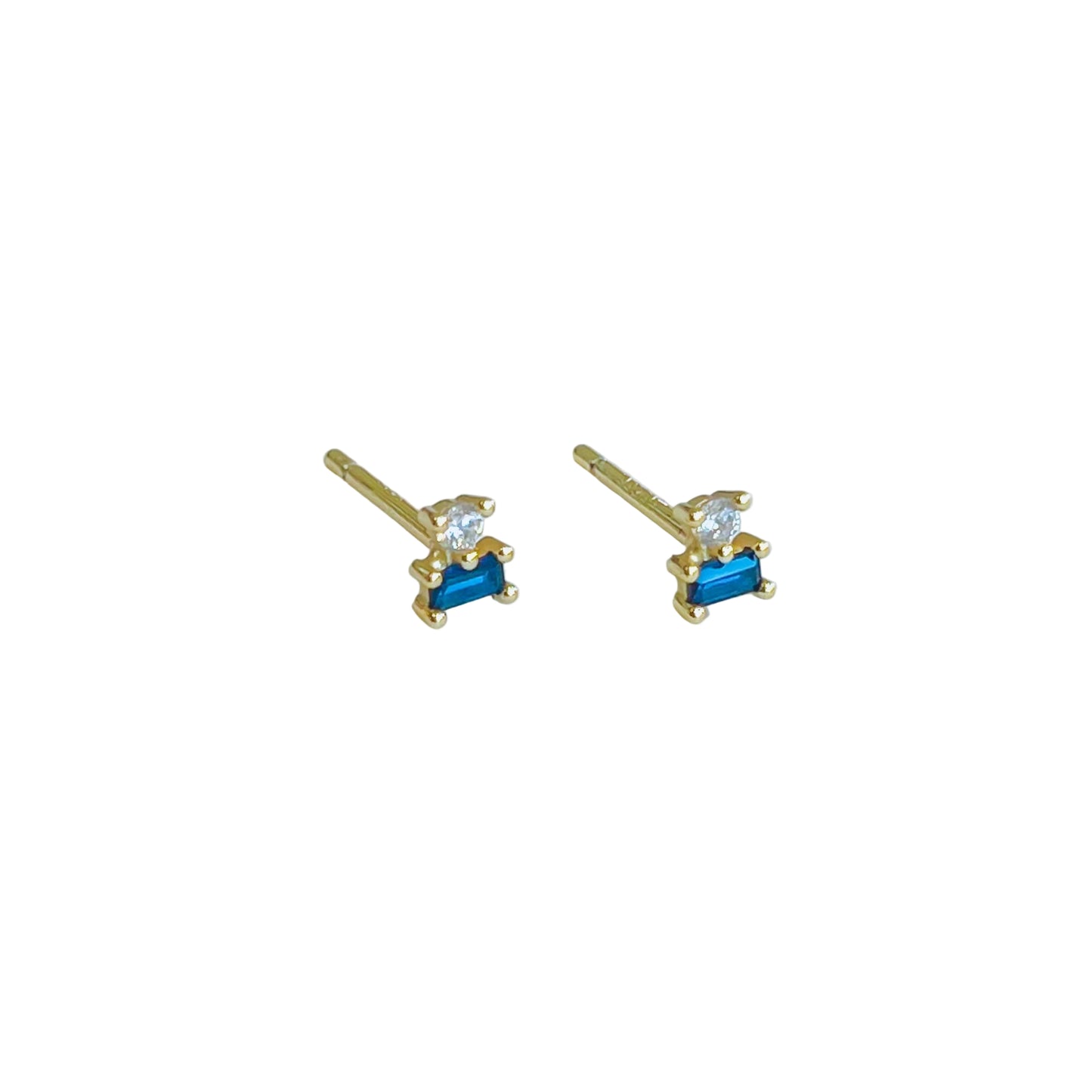 Double Gold Stud Stack - Sapphire Gold earrings with blue gemstones on a light background