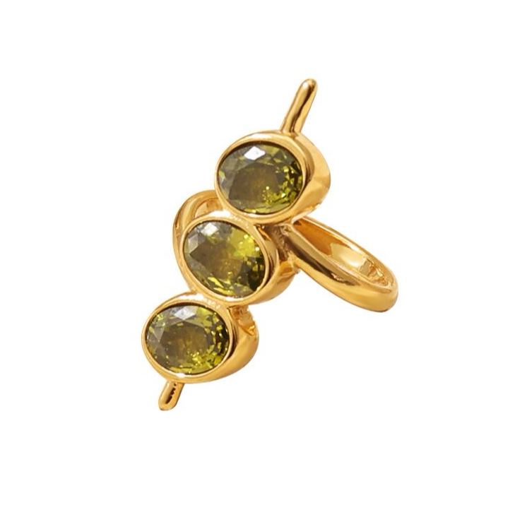 A gold-colored martini ring with three olive zircon stones.