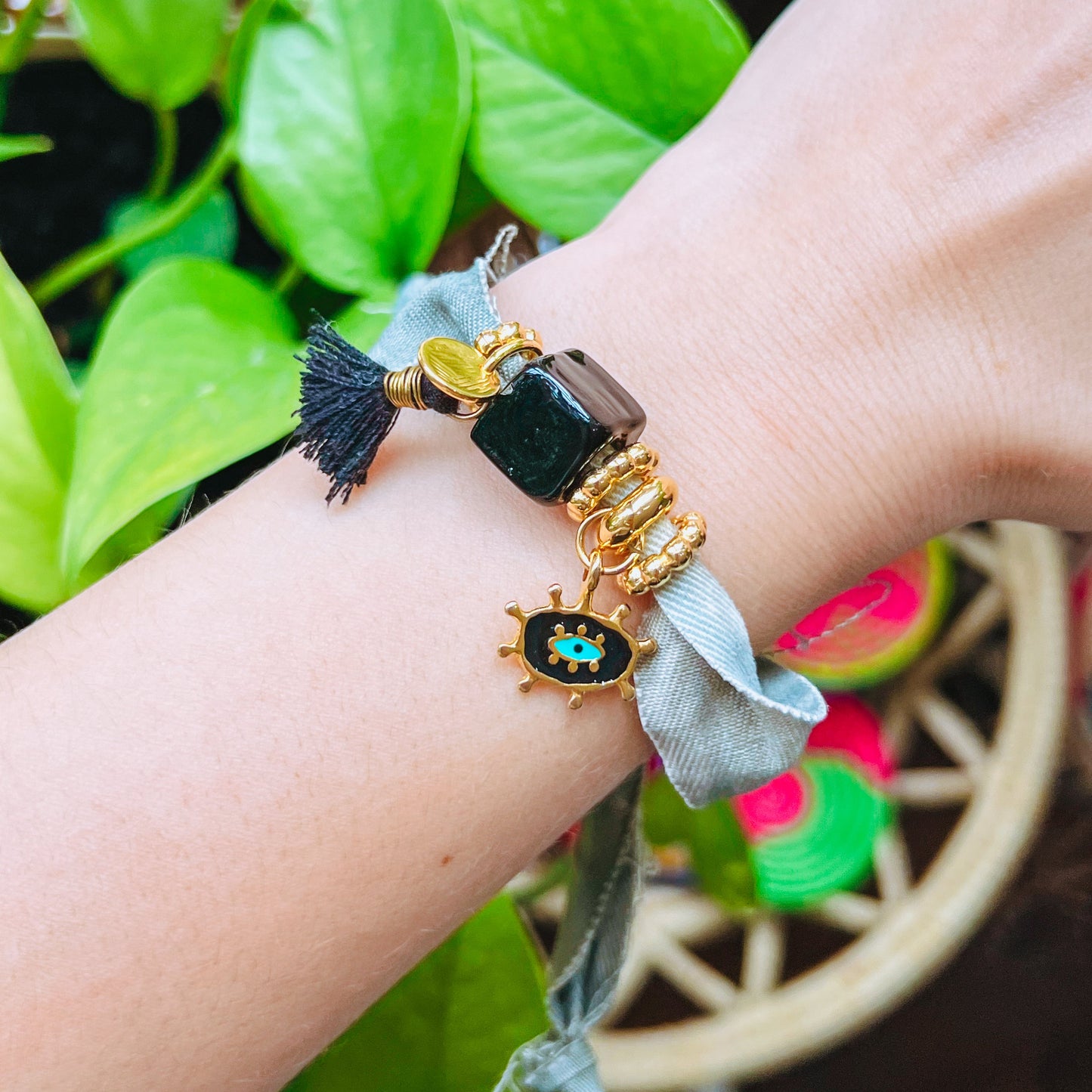 Gold and Black Denim Bracelet denim fabric Bracelet with beads and gold accents on a wrist 