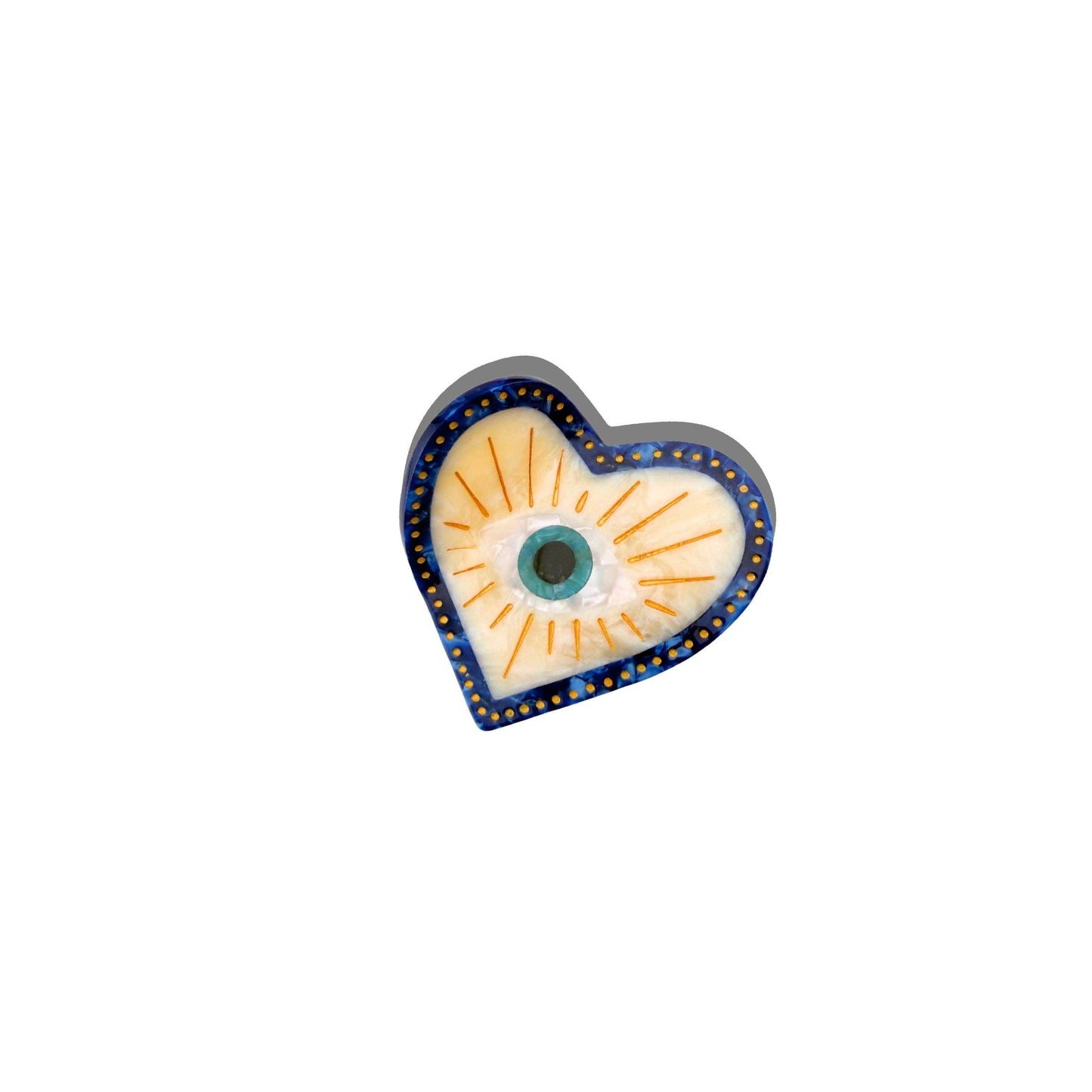 Heart-shaped hand-painted hair clip with a central evil eye design on a white background