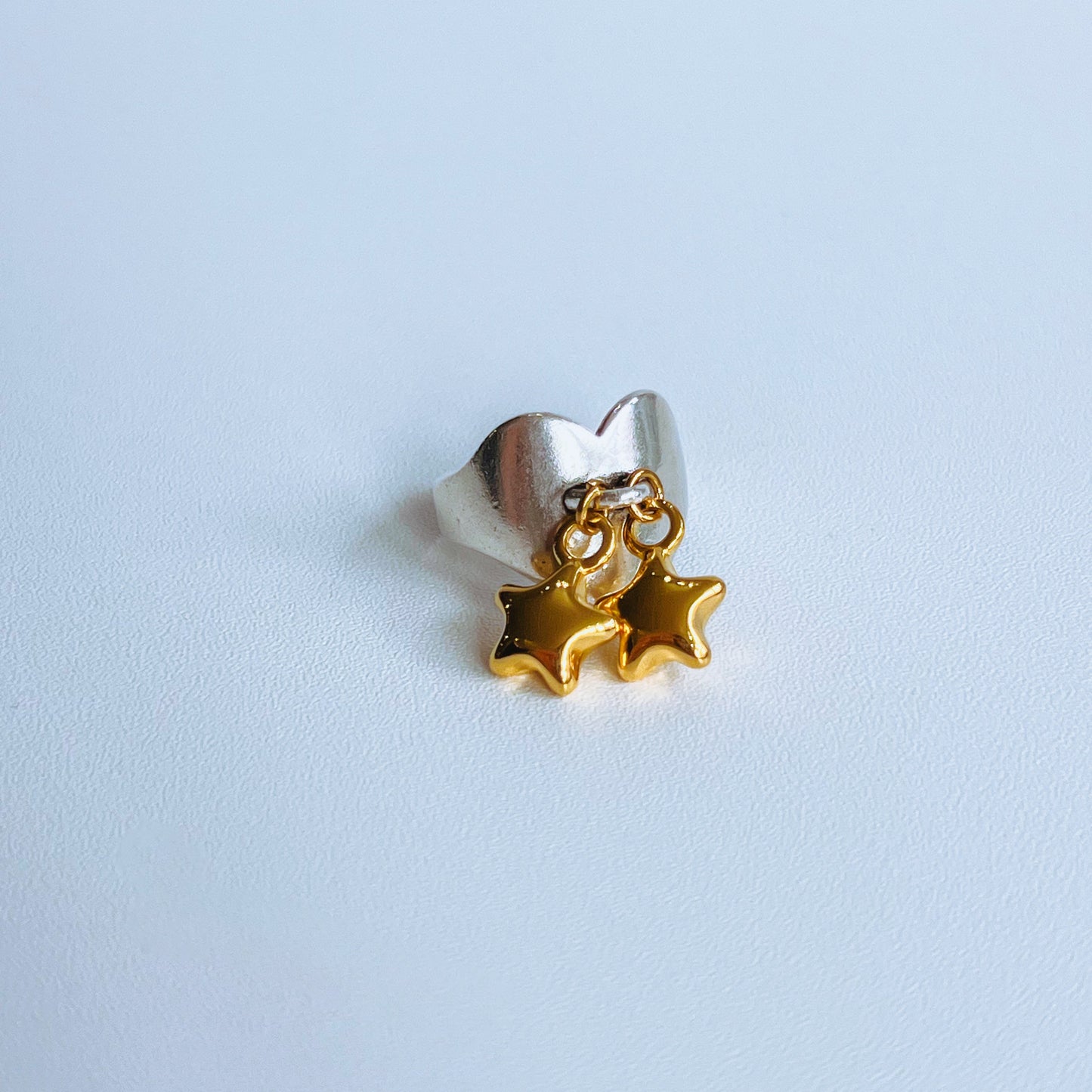 Stars Heart Ring - Gold mixed metal Silver ring with gold star charms on a light background