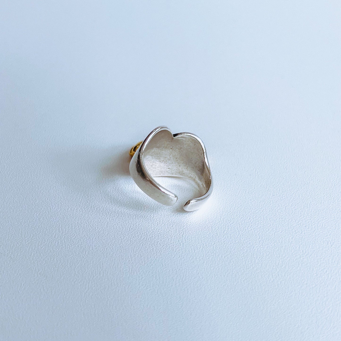 Stars Heart Ring - Gold back of Silver ring with a gold accent start charm on a light background