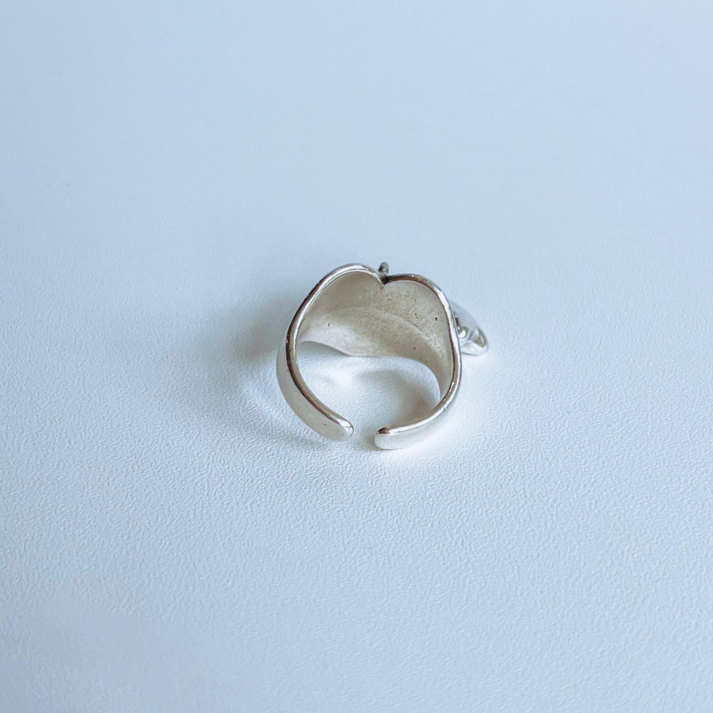 Stars Heart Ring - Silver plated Silver ring with two balloon star charms on a light background