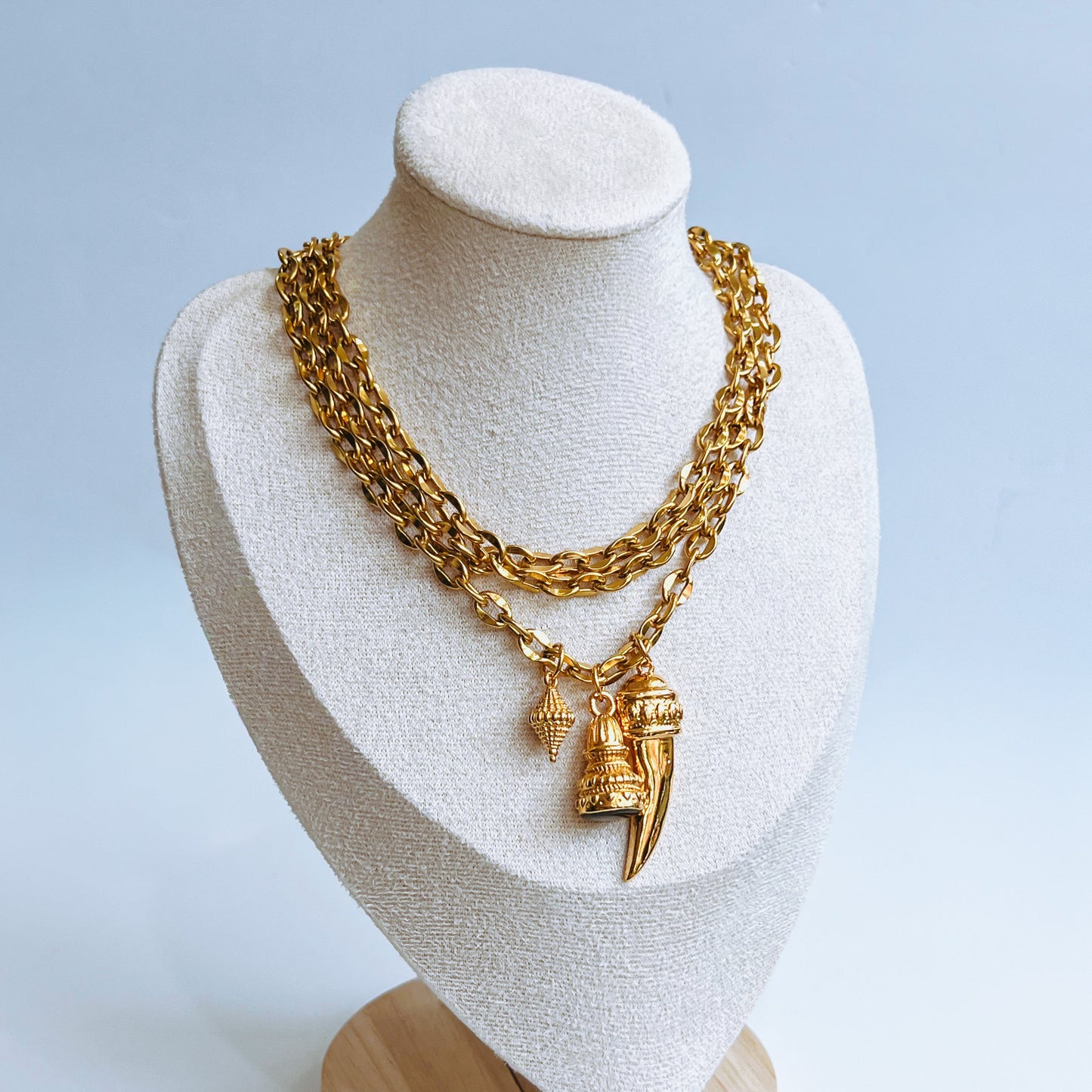 Top Triple Choker triple layer Gold chain necklace on a mannequin bust with a light background