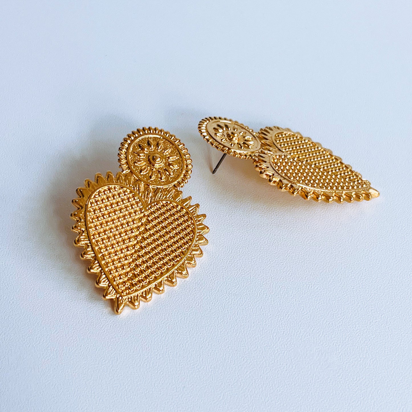 Vintage Heart Earrings - Gold heart earrings on a light background