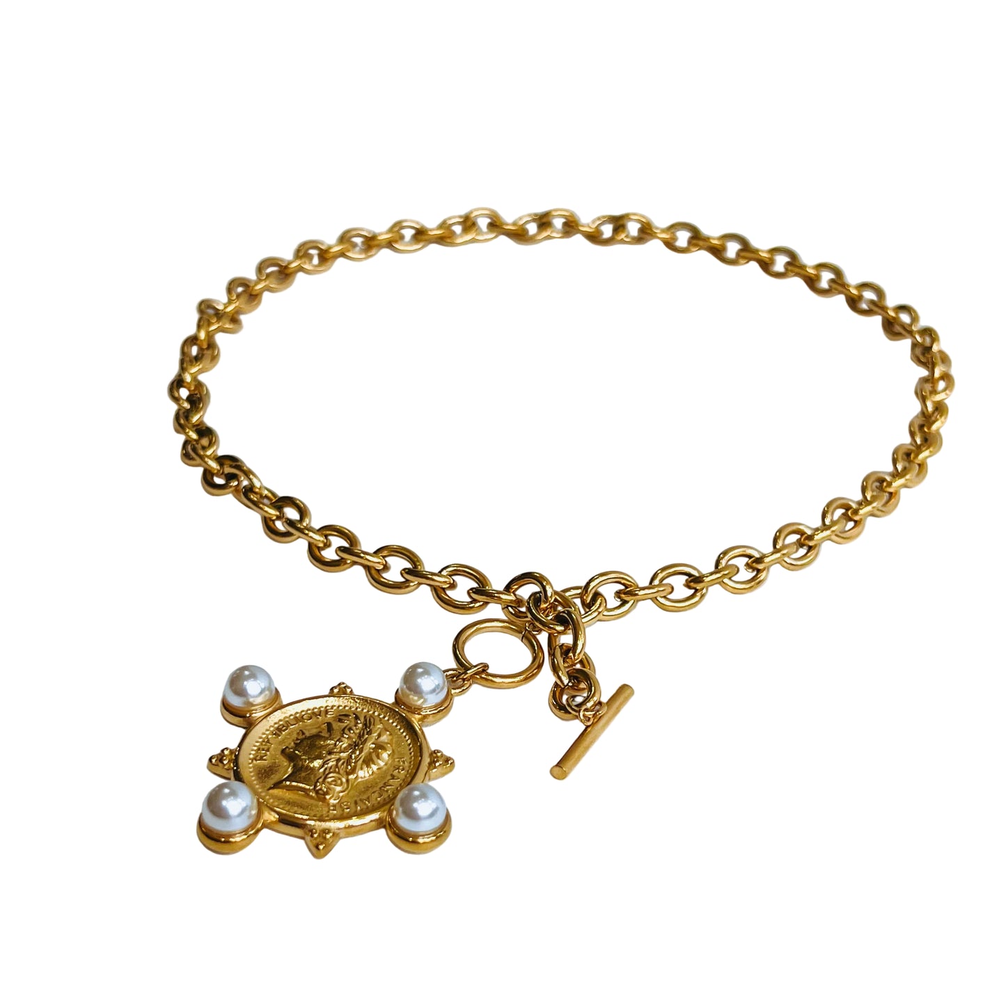 La Perla Coin gold Necklace with turtle charm and toggle clasp laid open on a light background