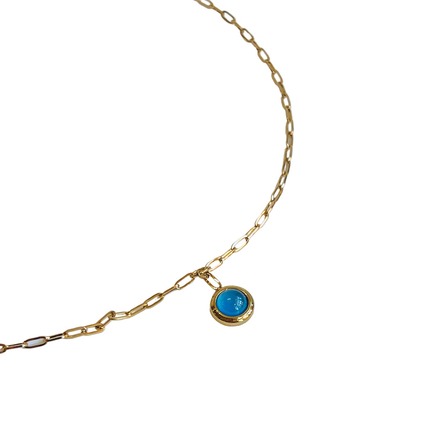 Azure Pendant Necklace Gold chain necklace with a blue pendant on a light background