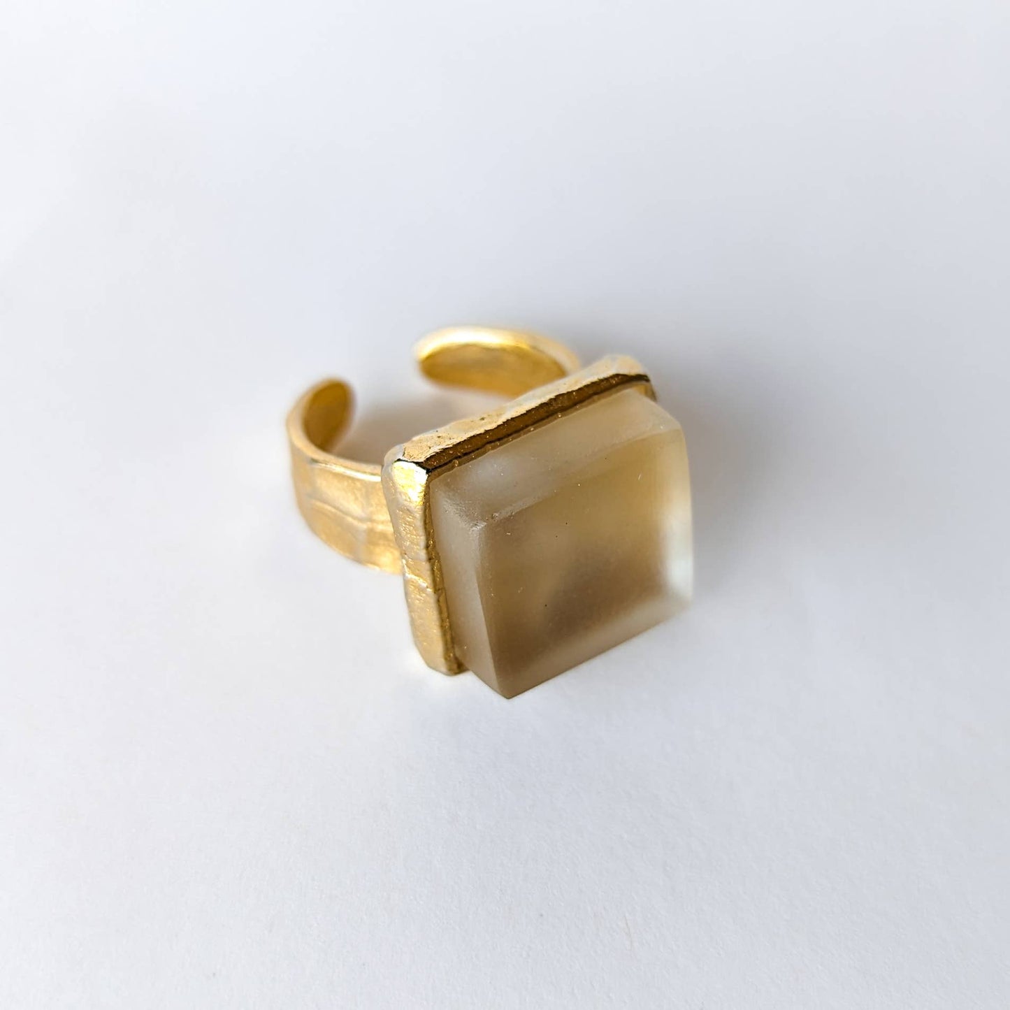 Gold recycled glass cube statement ring with a square recycled glass stone on a white background