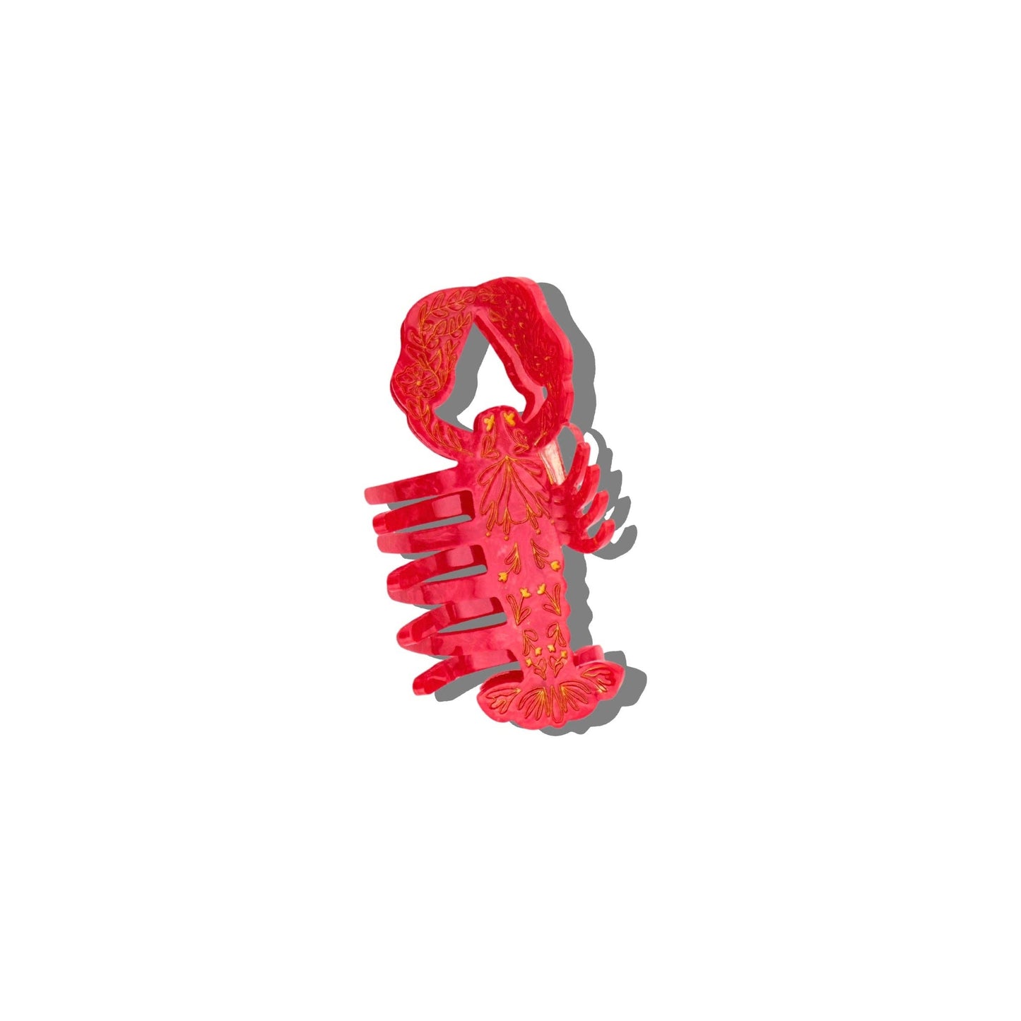 Red lobster-shaped hair clip on a white background