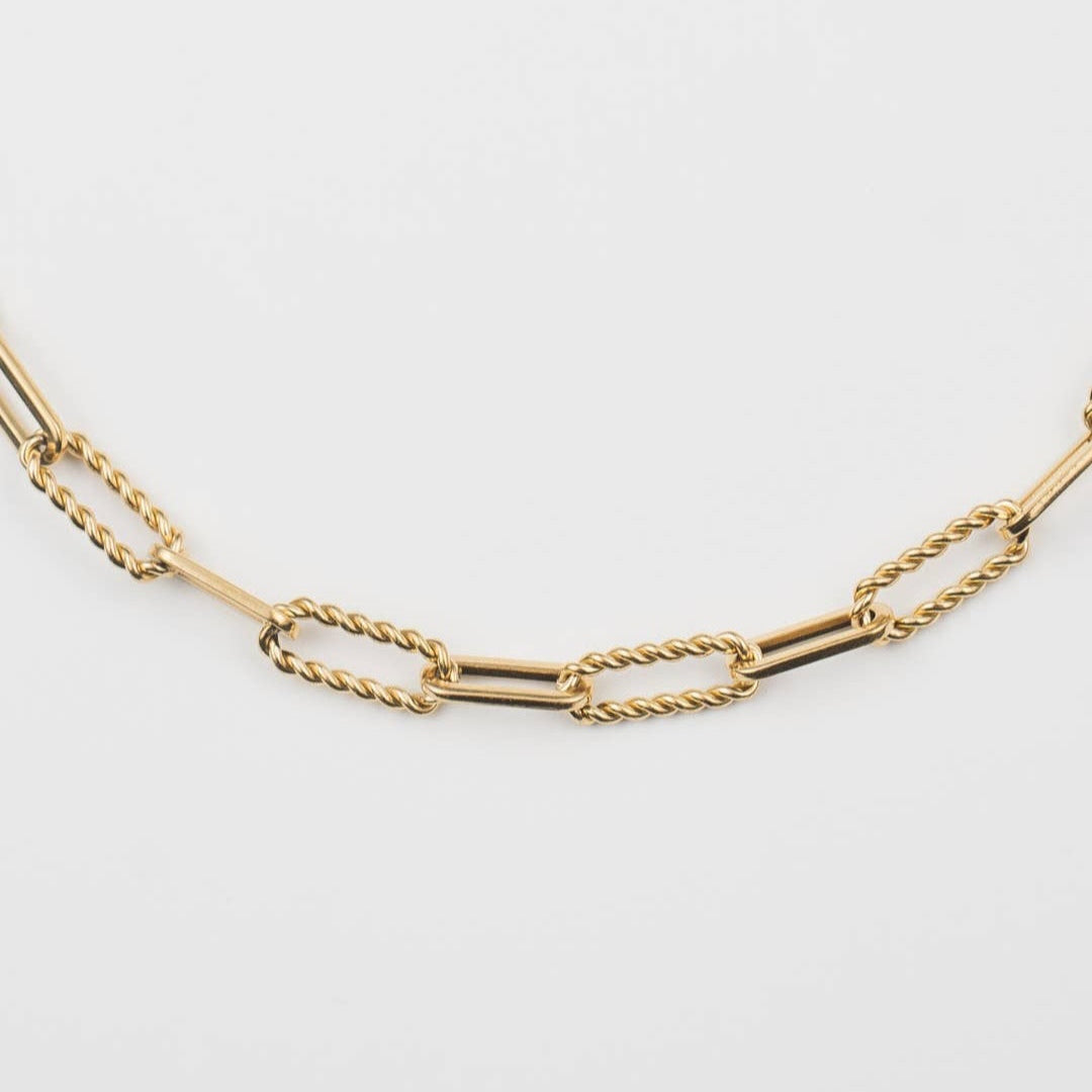 Gold chain necklace close-up on a light background